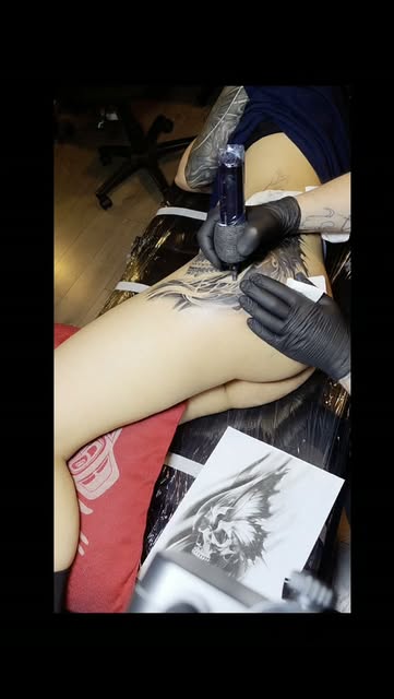 Skull thigh piece. In progress, with the drawing it started from.